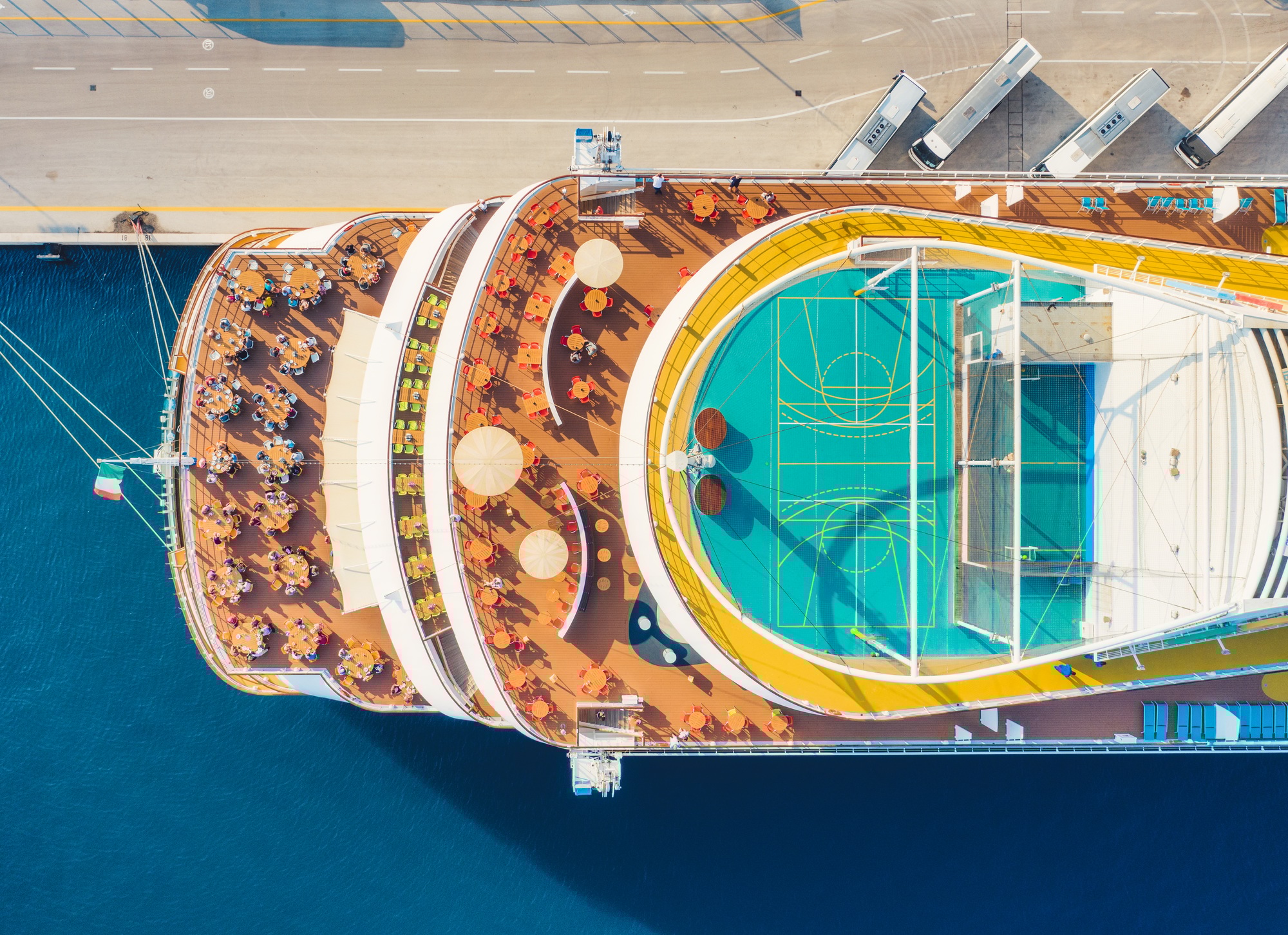 Aerial view of swimming pool, sunbeds, umbrellas on cruise ship