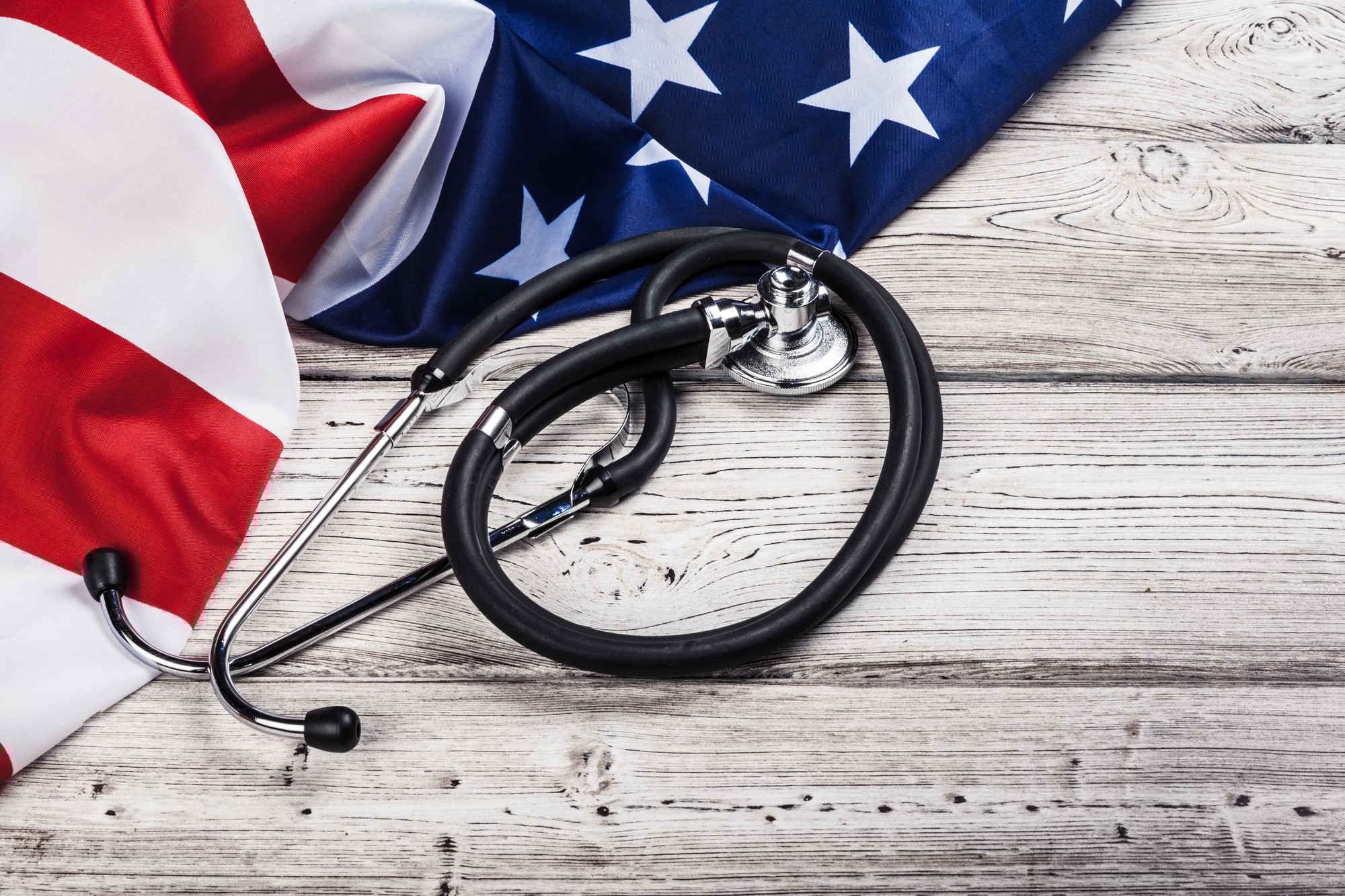 Close-up Photo Of Stethoscope On American USA Flag Close-up Photo Of Stethoscope On American USA Flag