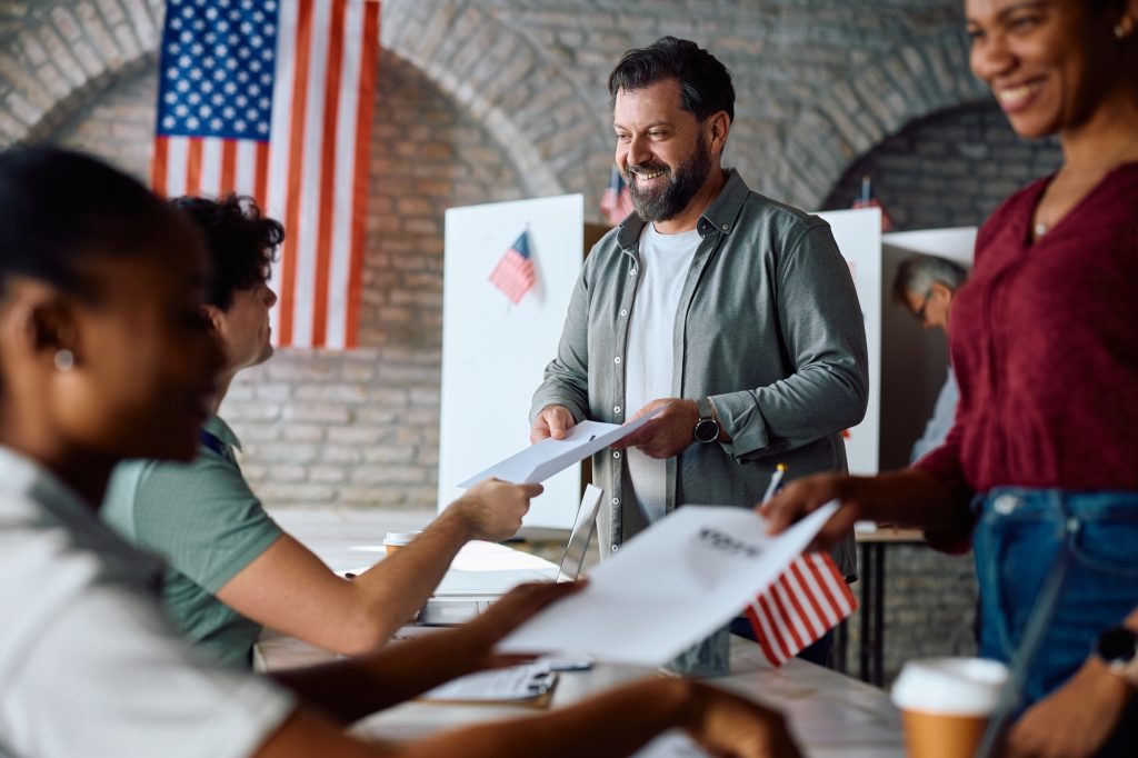 Happy mature man signing up to vote during US elections.