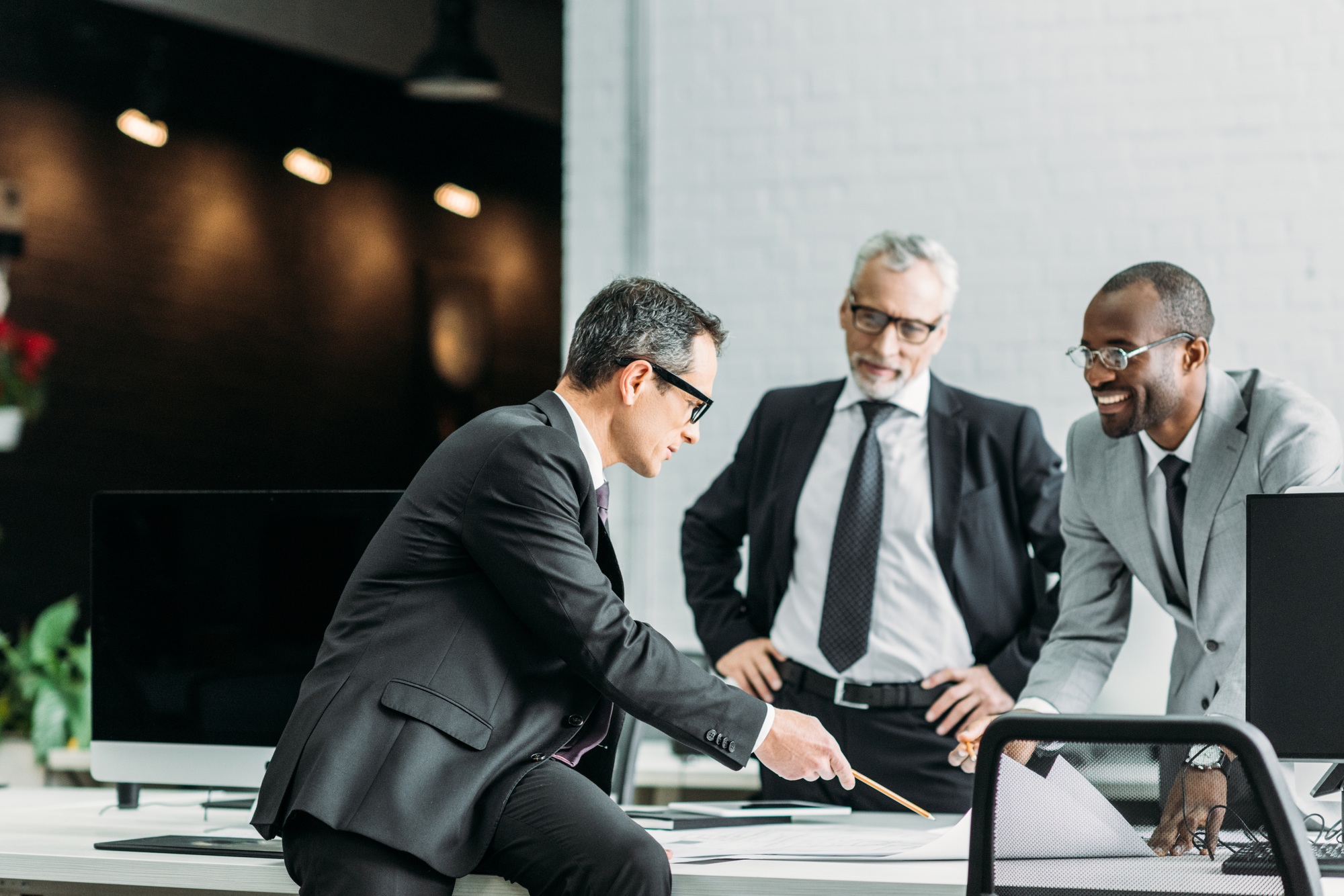 multiethnic businessmen discussing new business strategy on meeting in office multiethnic businessmen discussing new business strategy on meeting in office