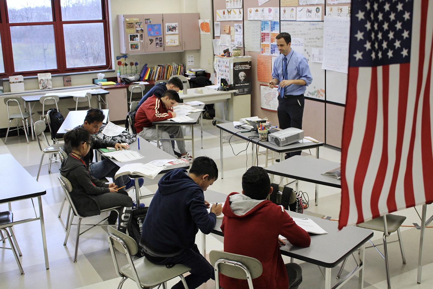 In this Feb. 15, 2017, photo, Eric Hoover teaches his class of immigrant and refugee students at McCaskey High School in Lancaster, Pa. The Lancaster community runs an "international school" on its main high school campus to help the waves of new arrivals sponsored by local resettlement agencies learn English and adjust to American schools. (AP Photo/Michael Rubinkam)